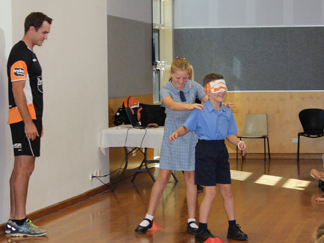 Students attempt an obstacle course blind-folded